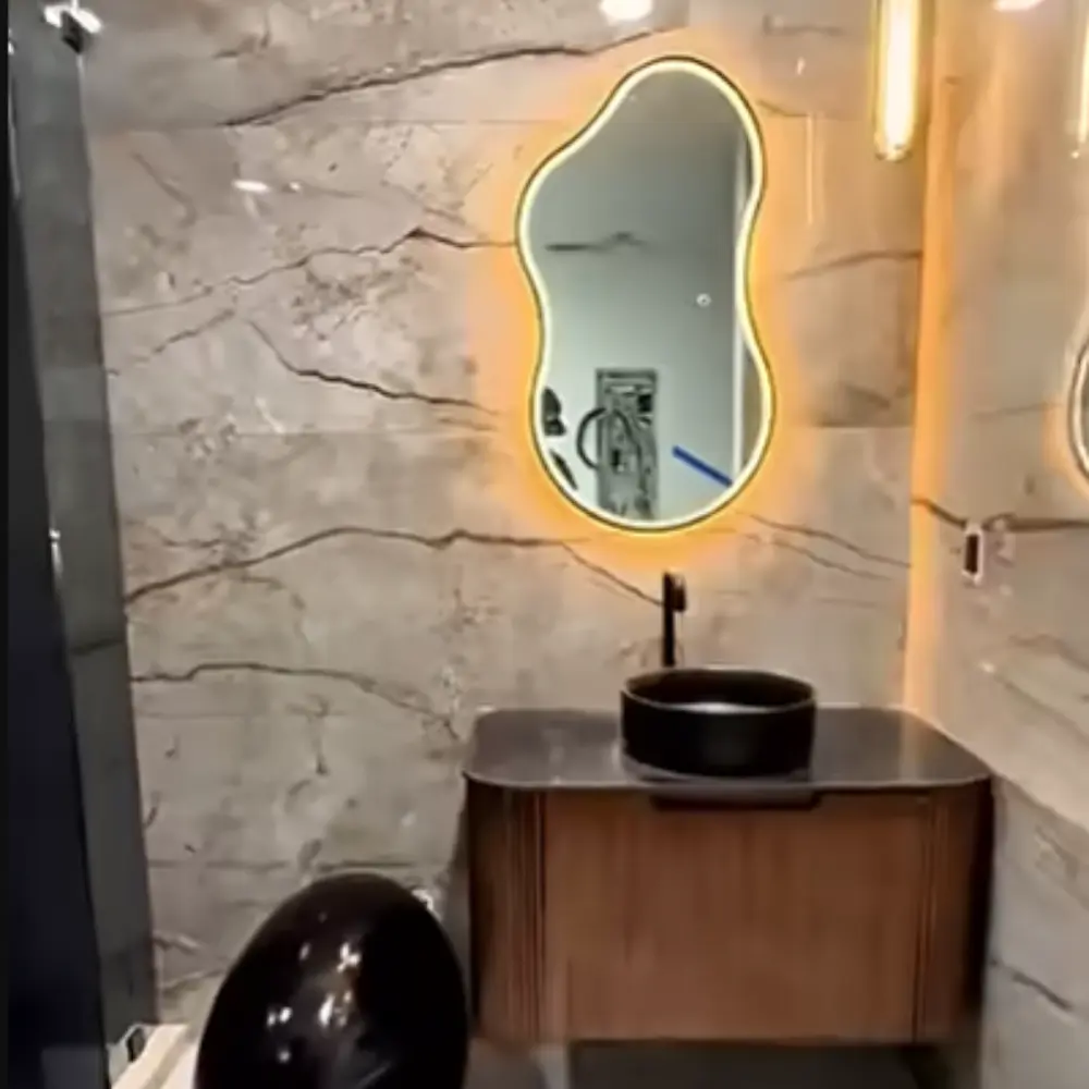 Organic-shaped backlit mirror – latest bathroom design trend