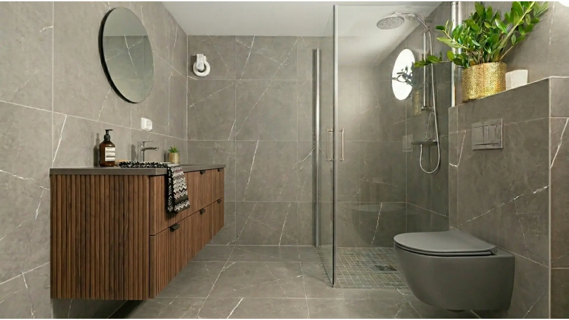 Grey porcelain tile bathroom featuring rust-resistant hardware and anti-fog mirror